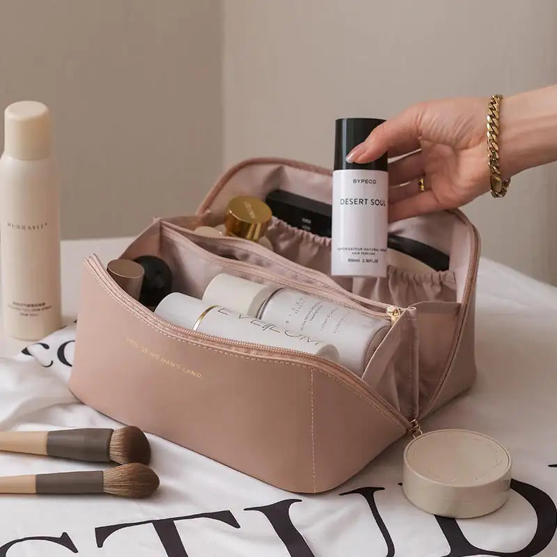 Inside view of spacious makeup bag with skincare and beauty items

